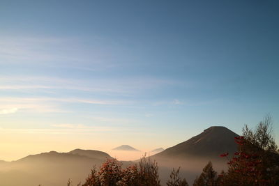 Scenic view of silhouette mountains against sky at sunset