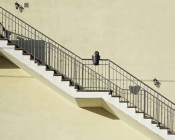 Man on staircase against wall