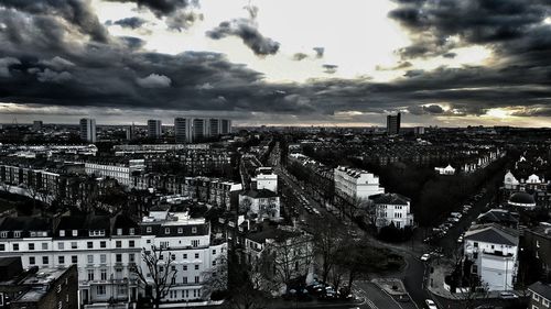 View of cityscape against cloudy sky