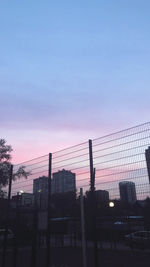 Low angle view of silhouette buildings against sky at sunset