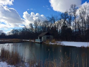 Scenic view of lake by building against sky
