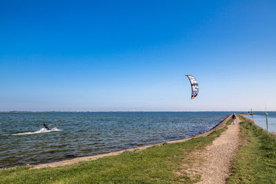 Scenic view of sea against clear blue sky