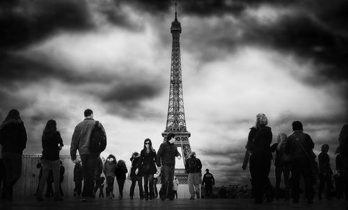 Eiffel tower against cloudy sky