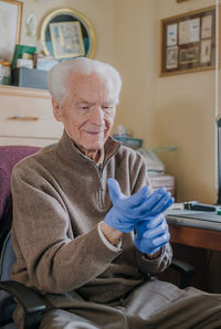 Senior man wearing gloves