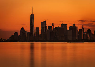 View of city at waterfront during sunset