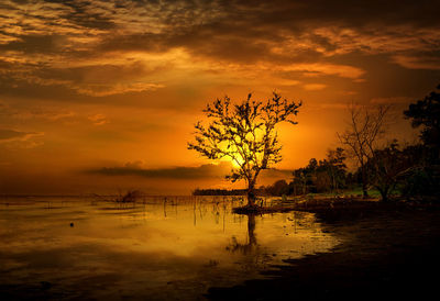 Scenic view of lake against orange sky