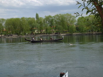 Man on boat in sea against sky