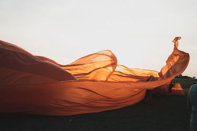 Man relaxing on land against clear sky