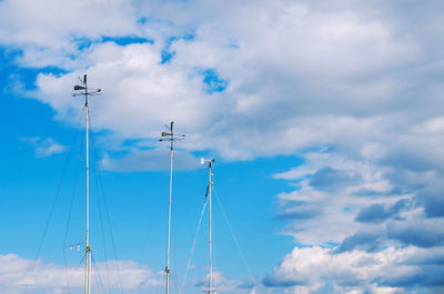 Low angle view of wind vane against sky