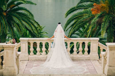 Rear view of bride standing at balcony