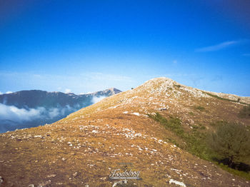 Scenic view of mountains against clear blue sky