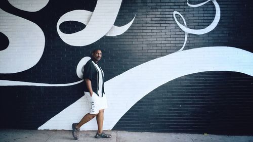 Man walking by wall