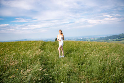 Full length of man standing on field against sky