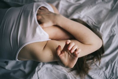 High angle view of woman lying on bed at home