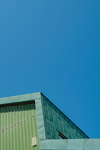 Low angle view of building against clear blue sky