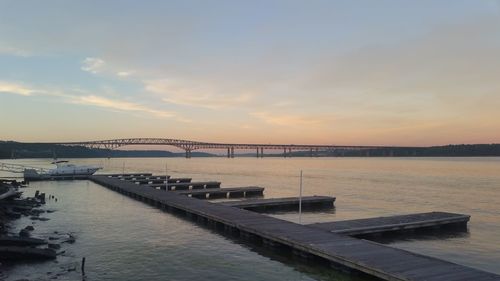 Bridge over river against sky during sunset