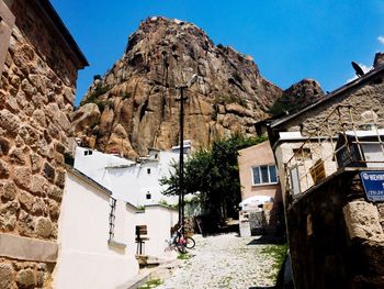 Low angle view of buildings in town against clear sky