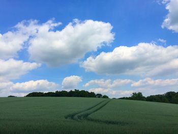 Scenic view of field against cloudy sky