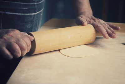 Midsection of person making dumpling