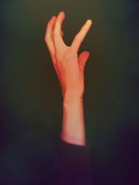 Close-up of woman hand against black background