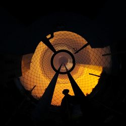 Silhouette man standing against orange sky