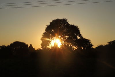 Silhouette trees against sky during sunset