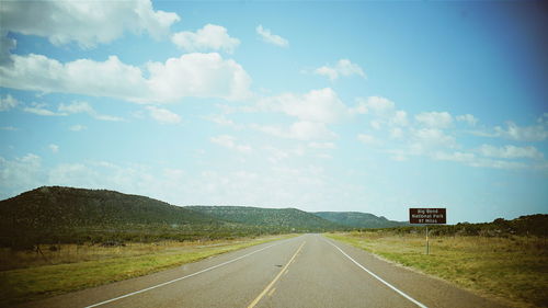 Empty road along trees