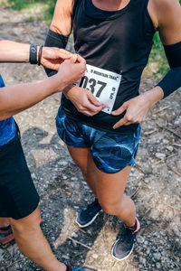 Low section athletes sticking label on clothes