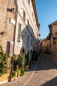 Street amidst buildings against sky in city