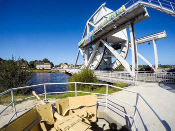 View of the pegasus  bridge over river against clear sky. on the foreground, a german anti tank gun