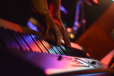 Cropped image of musician playing keyboard instrument