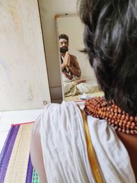 Rear view of man and woman standing at home