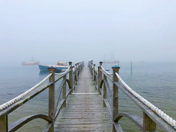 Pier over sea against sky