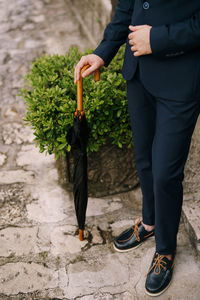 Low section of man with umbrella