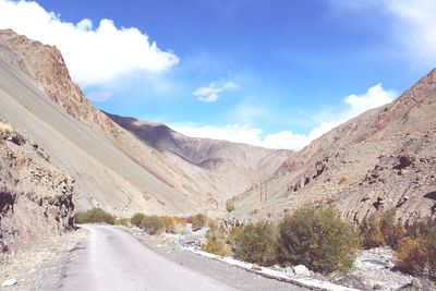 Road amidst mountains against sky