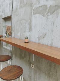 Empty chairs and table against wall at home