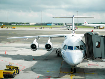 Airplane on runway against sky