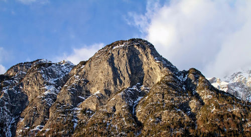 Low angle view of snowcapped mountain against sky