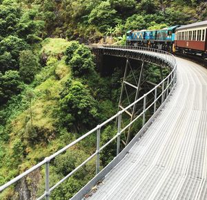 Train on railway bridge against mountain