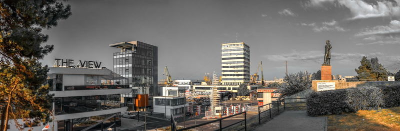 Illuminated buildings in city against sky