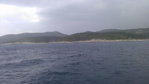 Scenic view of sea against cloudy sky