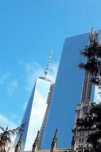 Low angle view of crane against sky