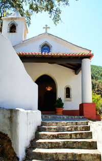 Low angle view of staircase by building against sky