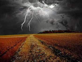 Scenic view of lightning over field