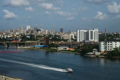 Boats in river with buildings in background