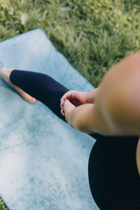 Low section of woman holding hands behind back 