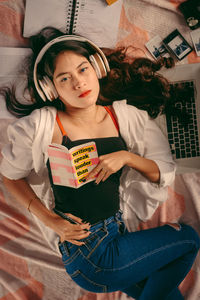 Portrait of a girl holding camera at home