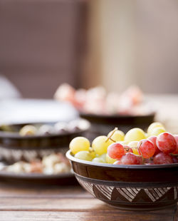 Antipasto food typical of the mediterranean including grapes, olives, salami in shallow focus