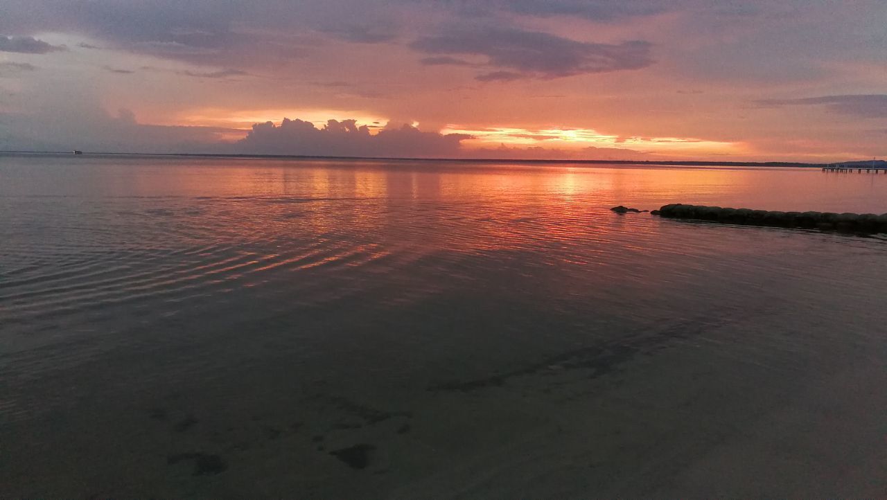 sunset, water, scenics, sky, reflection, tranquil scene, tranquility, beauty in nature, nature, cloud - sky, sea, orange color, idyllic, silhouette, outdoors, beach, no people, horizon over water, nautical vessel, day