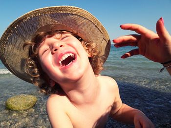 Portrait of boy wearing hat at beach